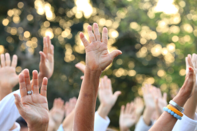 People raise their hands up for protest and uprising in demonstration event for unity and unanimous vote direct democracy
