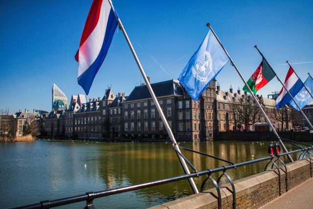 Dutch, United nations and afghan flags at parliament The Hague correctief bindend referendum